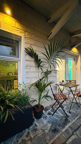 a patio with a table and plants next to a building at BBSUITE21 Maranello in Maranello