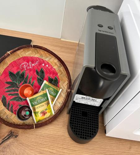 a printer sitting next to a basket of food at Logement PALMIER in Sainte-Rose