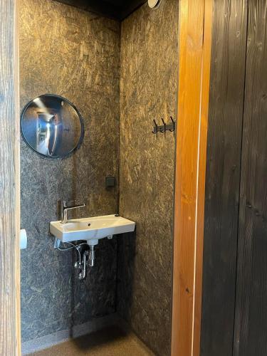 a bathroom with a sink and a mirror at Vetsi Talli Holiday Village in Kassari