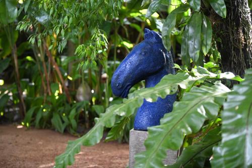 a blue figurine sitting on top of a plant at The Fern Cove Villa - Colombo in Battaramulla