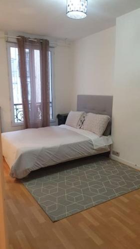 une chambre avec un lit dans une pièce dans l'établissement Joli deux pièces au 14ème arrondissement à Paris, à Paris