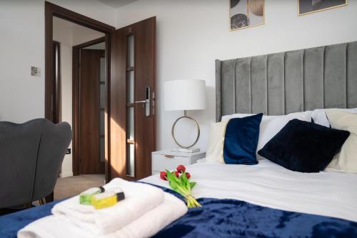 a bedroom with a bed with a blue blanket and a mirror at Renata's House in Bristol