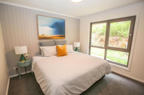 a bedroom with a large white bed and a window at Bright Views in Bright