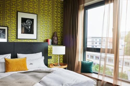 a bedroom with a large bed and a window at The George Hamburg in Hamburg