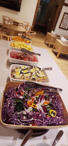 a table with several trays of food on it at Hanok Hotel DAAM Seoul in Seoul