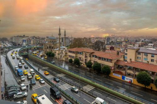 a city with a busy street with cars and buildings at Baver Hotel in Istanbul