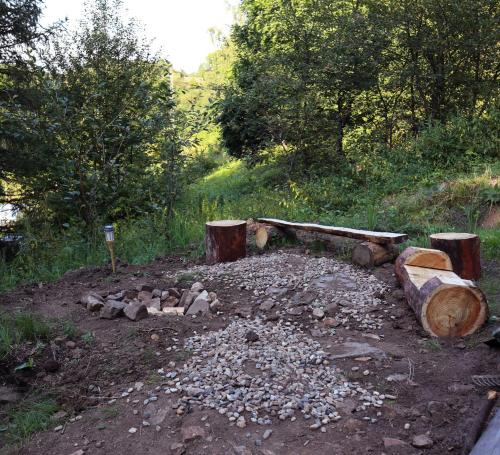a pile of logs and rocks on a dirt road at Krondorf and Spa JURTA in Kamenec