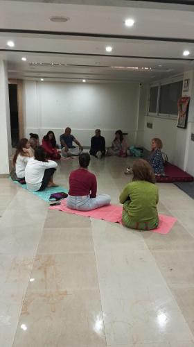 a group of people sitting on the floor in a room at D's Casa - A Unique Spanish Boutique House in McLeod Ganj