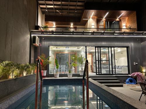 a swimming pool in the middle of a building at Ganga Euphoria - A Luxury Villa on the Ganges in Rishīkesh