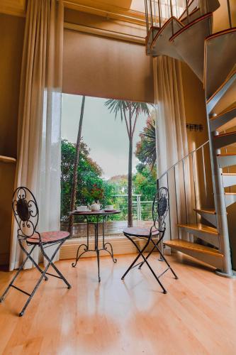 a living room with a table and chairs and a large window at Sutherland Estate - Stunning Yarra Valley Vineyard in Dixons Creek