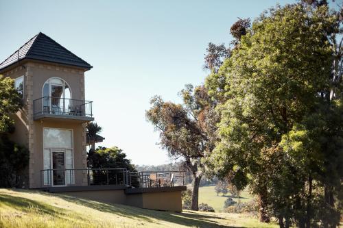 a building on top of a hill with trees at Sutherland Estate - Stunning Yarra Valley Vineyard in Dixons Creek