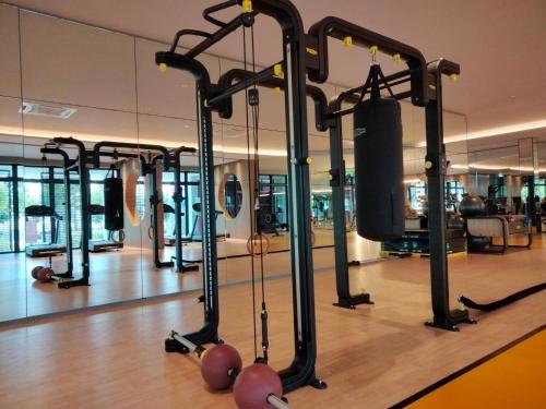 a gym with a lot of treadmills and weights at Continew Residence by HomeBrickz in Kuala Lumpur