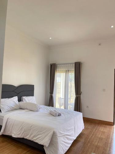 Ένα ή περισσότερα κρεβάτια σε δωμάτιο στο Abhizar Bungalow