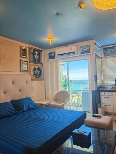 a bedroom with a bed and a view of the ocean at Art Under the Clouds 32nd floor sea view SuperHost in North Pattaya