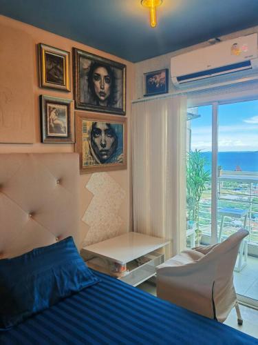 a bedroom with a bed and a view of the ocean at Art Under the Clouds 32nd floor sea view SuperHost in North Pattaya