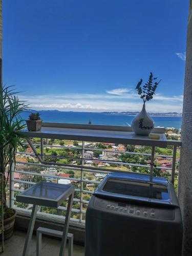a balcony with a stove and a view of a city at Art Under the Clouds 32nd floor sea view SuperHost in North Pattaya