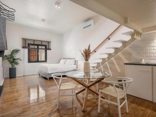 a living room with a table and a bed at Faedra Residence in Chania Town