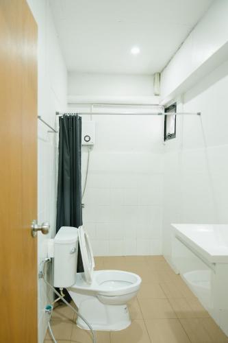 a bathroom with a toilet and a sink at Home Story Hostel Chiang Mai in Chiang Mai