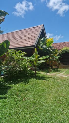 a house with a roof and a grass yard at MILLET'S FOOD COMPANY AND COOKING CENTER in Negombo