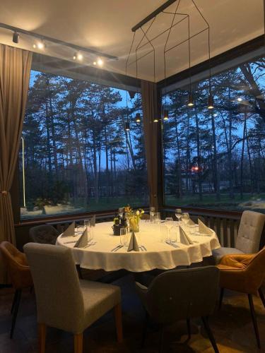 a dining room with a table and a large window at Hotel Les in Razgrad