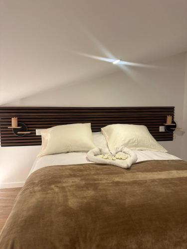 a bedroom with a large bed with a wooden headboard at Hôtel du Parc Canal - Stade de France in Saint-Denis