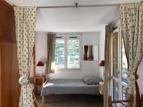 Ένα ή περισσότερα κρεβάτια σε δωμάτιο στο Pra-Loup 1500 Appartement spacieux et lumineux