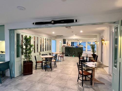 a restaurant with tables and chairs in a room at Best Western Adelaide Airport in Adelaide
