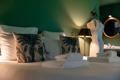 a bedroom with a bed with towels on it at Les Pins de César - La campagne d'Etretat in Saint-Jouin-Bruneval