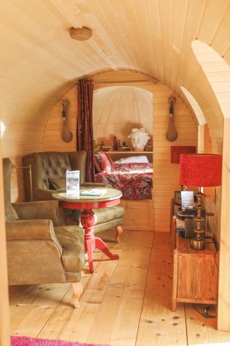 a living room with a couch and a table at Les Pins de César - La campagne d'Etretat in Saint-Jouin-Bruneval