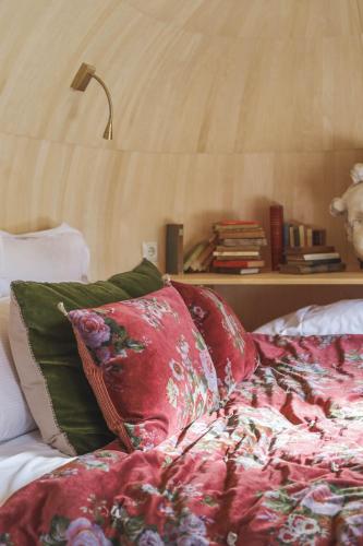 a bed with pillows and a lamp in a bedroom at Les Pins de César - La campagne d'Etretat in Saint-Jouin-Bruneval