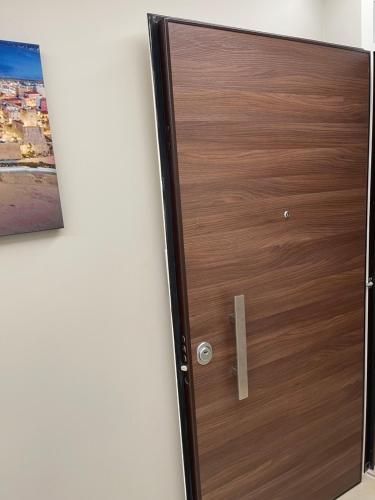 a wooden door in a room with a picture on the wall at Therma Luxury house in Termoli