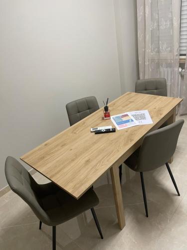 a wooden table with chairs and a book on it at Therma Luxury house in Termoli