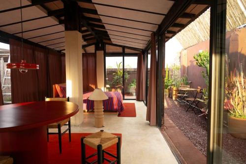 a room with a bed and a table and a dining room at Rooftop Glass House in Old Town in Oaxaca City