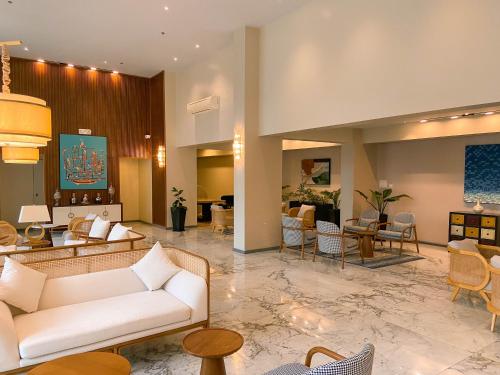 a lobby with a couch and tables and chairs at Staycity Serviced Apartment in Cebu City