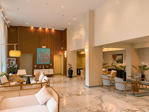 a lobby of a hotel with couches and chairs at Staycity Serviced Apartment in Cebu City