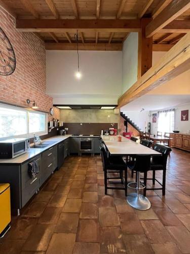 a large kitchen with a table and chairs in it at Maison PAU - BIZANOS in Bizanos