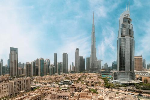 a view of a city with tall buildings at 5 Minute Walk to The Fountains! Full Burj Khalifa View! 5-star Pool & Gym! in Dubai
