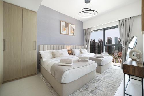 a bedroom with a large bed and a large window at 5 Minute Walk to The Fountains! Full Burj Khalifa View! 5-star Pool & Gym! in Dubai