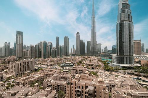 a view of a city with tall buildings at 5 Minute Walk to The Fountains! Full Burj Khalifa View! 5-star Pool & Gym! in Dubai