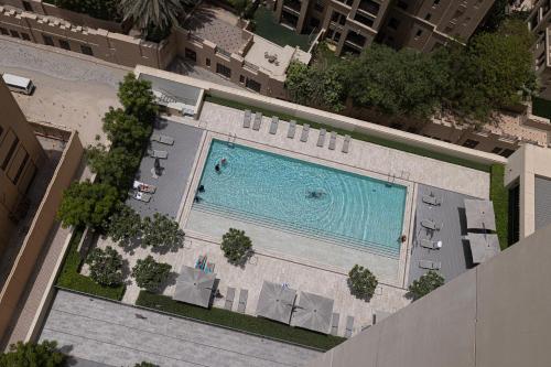 an overhead view of a swimming pool in a building at 5 Minute Walk to The Fountains! Full Burj Khalifa View! 5-star Pool & Gym! in Dubai