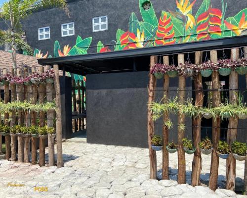 a fence with potted plants in front of a building at Funtasea Hotel and Beach Resort in Iba