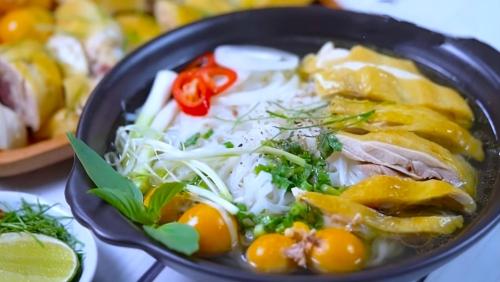 a black bowl of food with noodles and vegetables at MEDDOM Park in Cao Phong