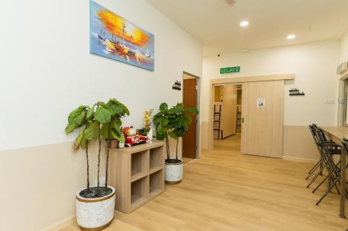 a hallway with two potted plants on the wall at LumaNest Senawang in Seremban