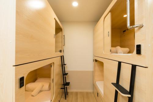 a small room with wooden cabinets and shelves at LumaNest Senawang in Seremban
