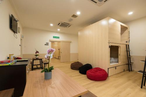 a living room with a table and a room with a room at LumaNest Senawang in Seremban