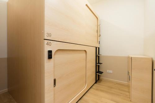 a closet with a wooden door in a room at LumaNest Senawang in Seremban