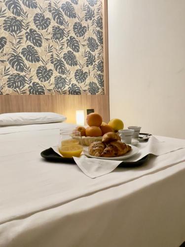 a tray of food on a bed with a plate of food at Aquasole in Mercallo