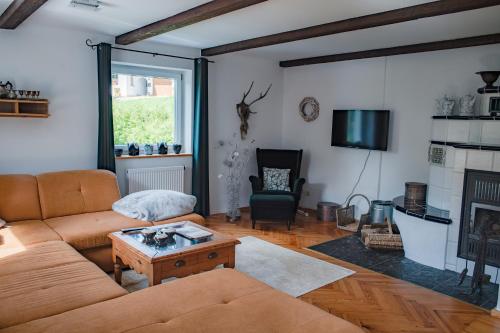a living room with a couch and a table at Das Alte Forsthaus Spiegelhütte in Lindberg