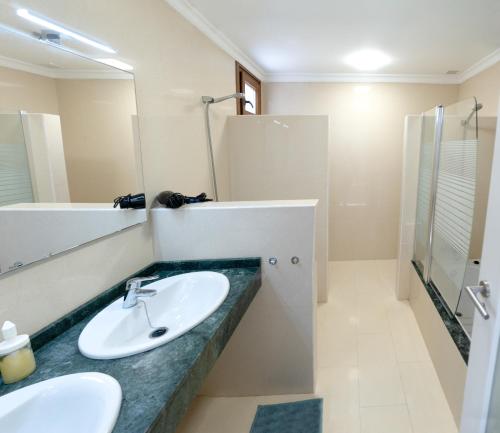 a bathroom with a sink and a shower and a mirror at CASA PARI in Playa Blanca