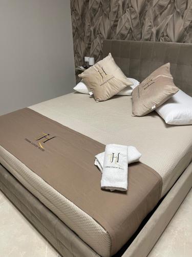 a bed with two pillows on top of it at Therma Luxury house in Termoli